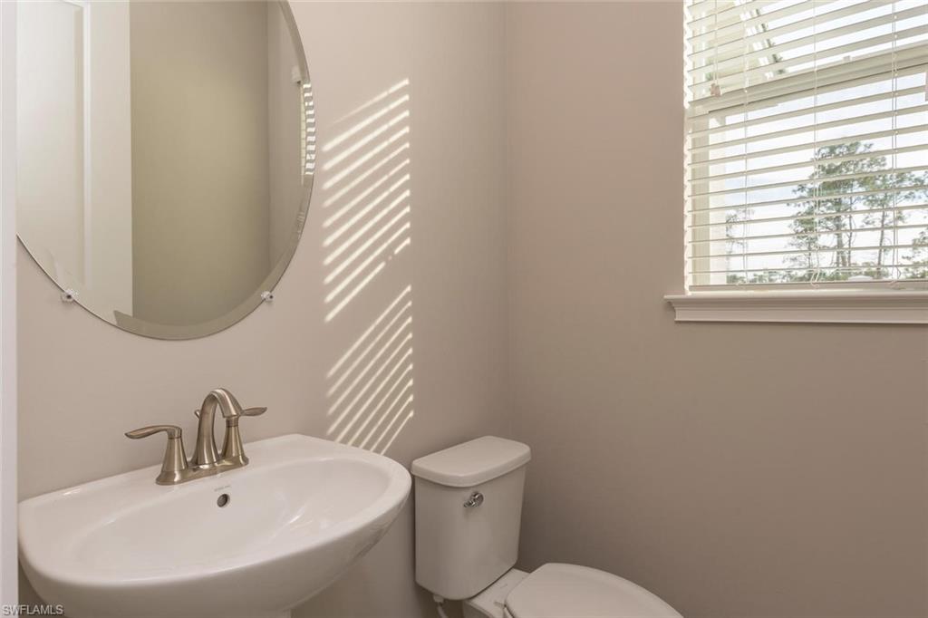 3331 Pilot Circle Naples, FL 34120 - Photo 15 of 28 a bathroom with a sink and a mirror