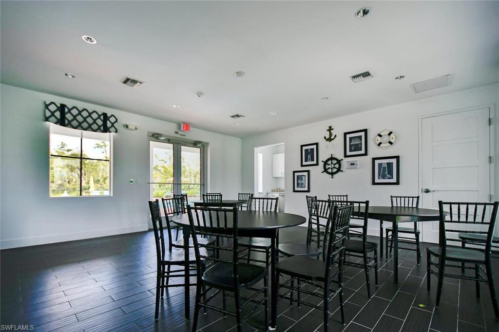 3331 Pilot Circle Naples, FL 34120 - Photo 22 of 28 a view of a dining room with furniture and wooden floor