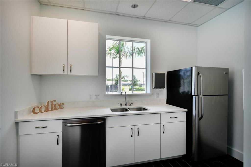 3331 Pilot Circle Naples, FL 34120 - Photo 23 of 28 a kitchen with appliances cabinets and a sink