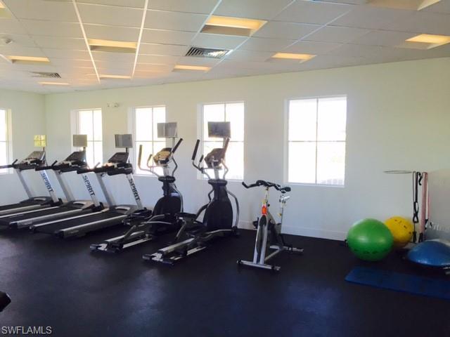 3331 Pilot Circle Naples, FL 34120 - Photo 25 of 28 a room with gym equipment and wooden floor