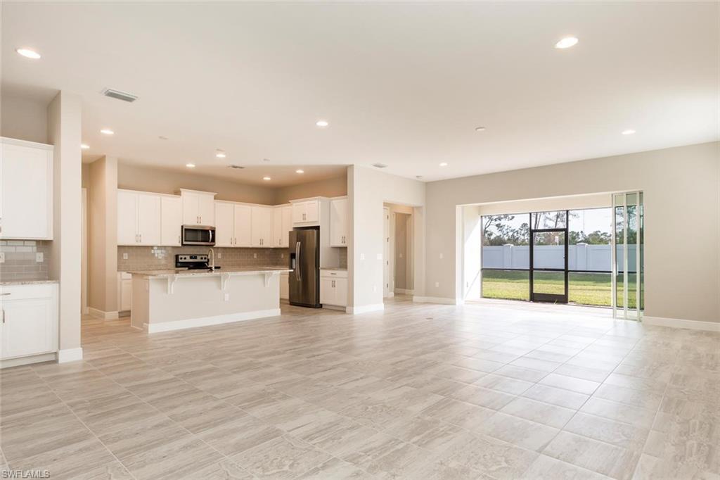 3331 Pilot Circle Naples, FL 34120 - Photo 3 of 28 a view of an empty room with kitchen view and a window