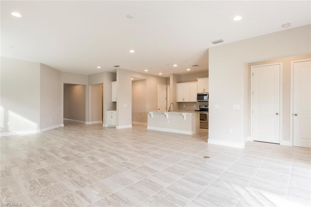 3331 Pilot Circle Naples, FL 34120 - Photo 5 of 28 a view of a kitchen with kitchen island and stainless steel appliances
