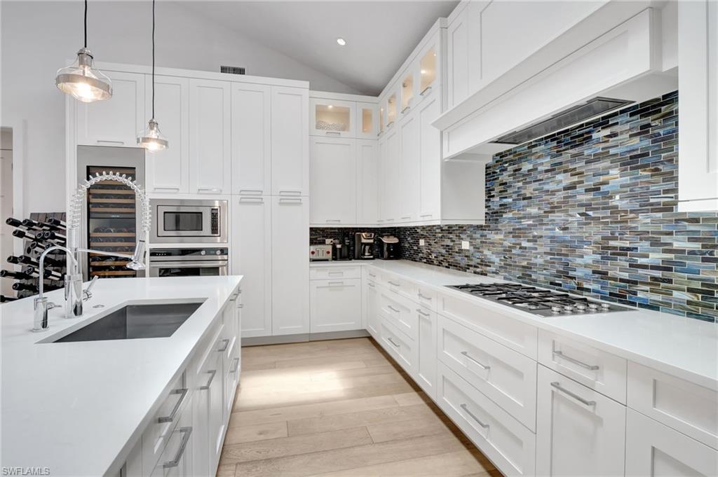 2120 Curtis Street Naples, FL 34112 - Photo 11 of 38 a kitchen with stainless steel appliances granite countertop a sink and a refrigerator