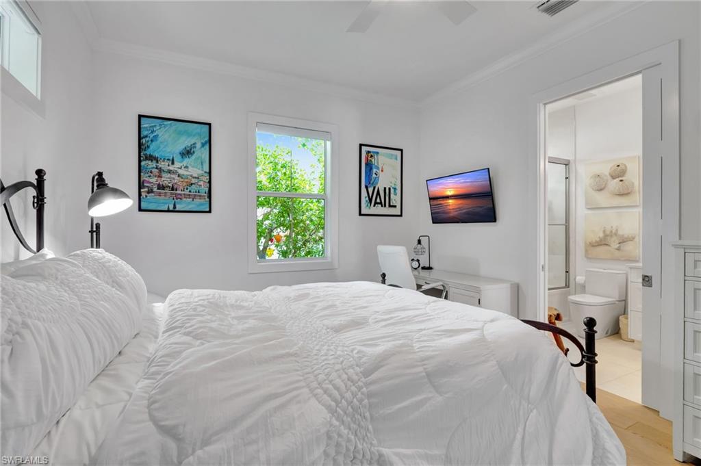 2120 Curtis Street Naples, FL 34112 - Photo 19 of 38 a bedroom with a bed and a flat screen tv