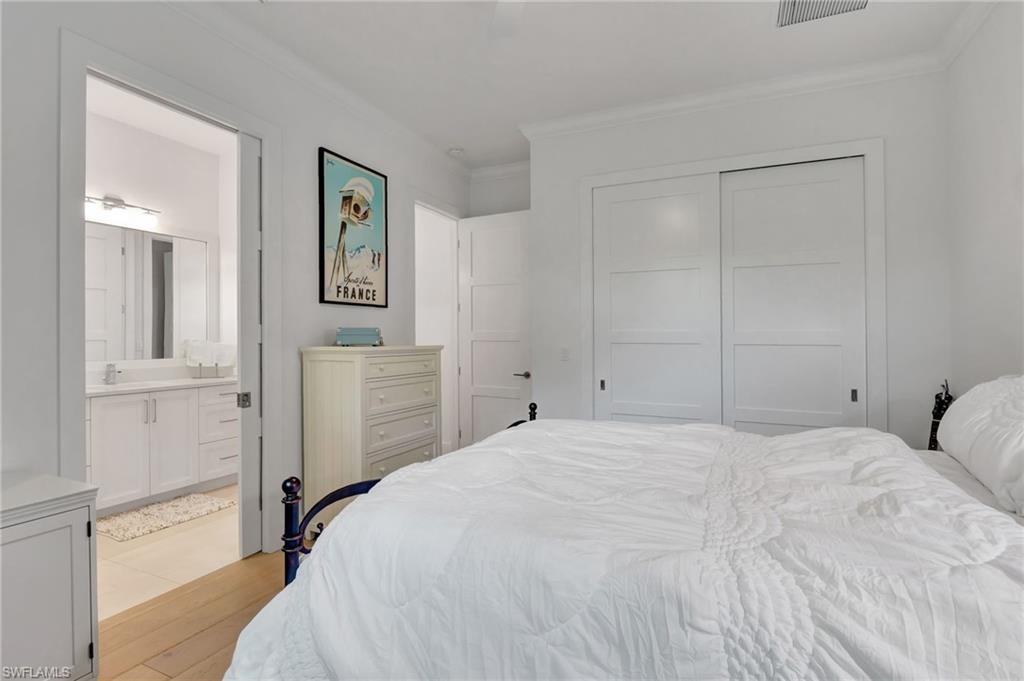 2120 Curtis Street Naples, FL 34112 - Photo 20 of 38 a bedroom with a bed and a lamp on dresser
