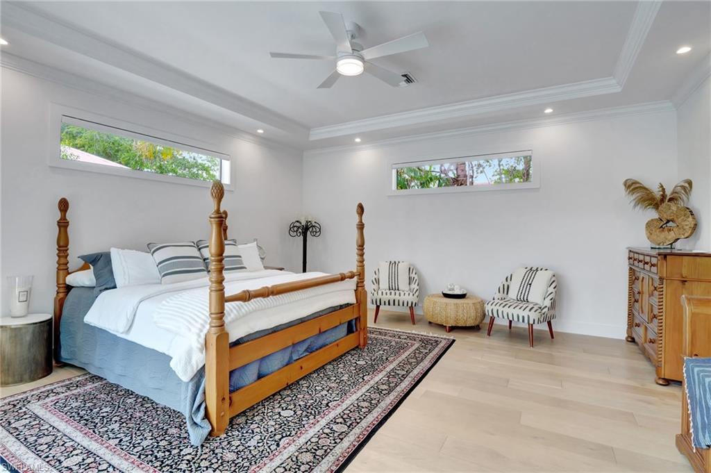 2120 Curtis Street Naples, FL 34112 - Photo 23 of 38 a bedroom with a bed and wooden floor