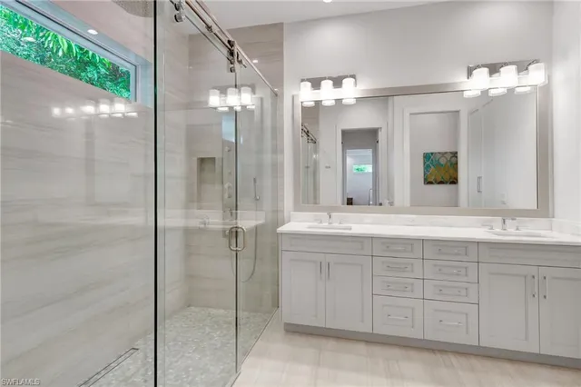 a bathroom with a double vanity sink and a mirror