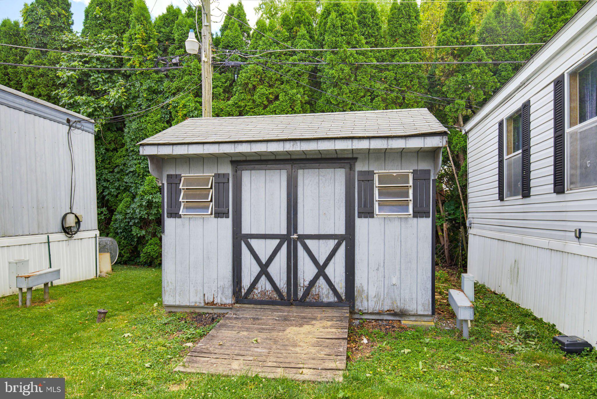 475 Wabash Road Ephrata, PA 17522 - Photo 33 of 33 Charming shed nestled in lush greenery.