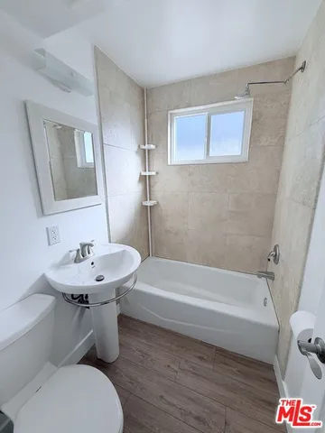 a bathroom with a sink a toilet and bathtub