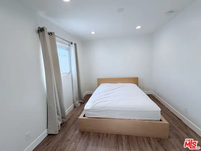 a bedroom with a bed and a mirror