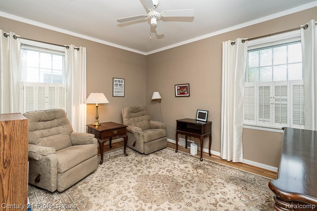 304 Highland Avenue Rochester, MI 48307 - Photo 11 of 30 Room with light tan walls, crown molding, and wood-finish flooring