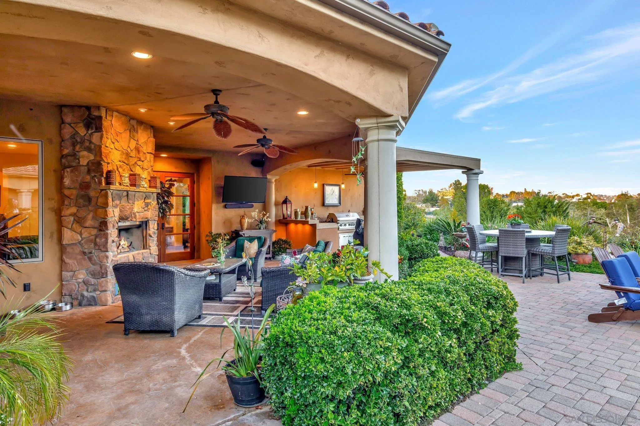 3401 Preakness Court Fallbrook, CA 92028 - Photo 12 of 52 a view of a patio with table and chairs potted plants and floor to ceiling window