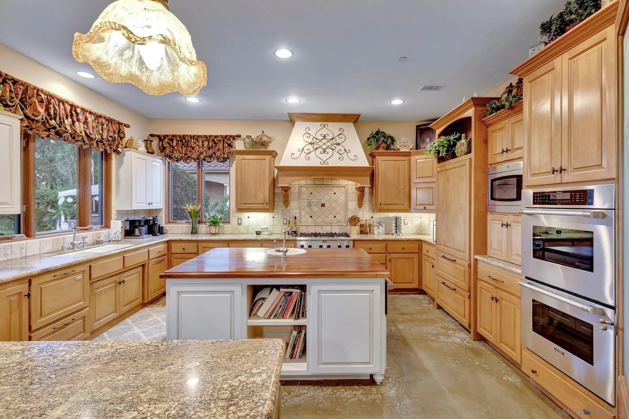 3401 Preakness Court Fallbrook, CA 92028 - Photo 20 of 52 a large kitchen with stainless steel appliances granite countertop a stove and cabinets