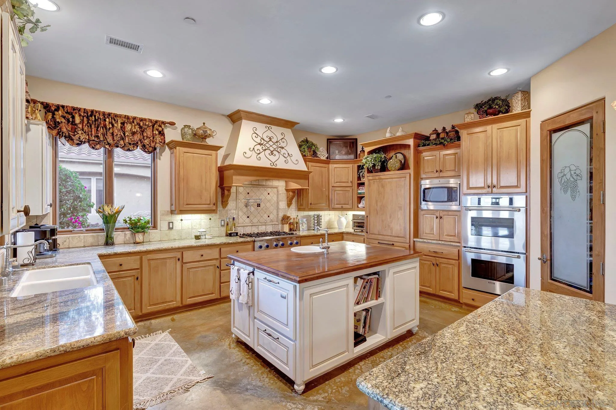 3401 Preakness Court Fallbrook, CA 92028 - Photo 21 of 52 a kitchen with stainless steel appliances granite countertop a stove a sink and a refrigerator