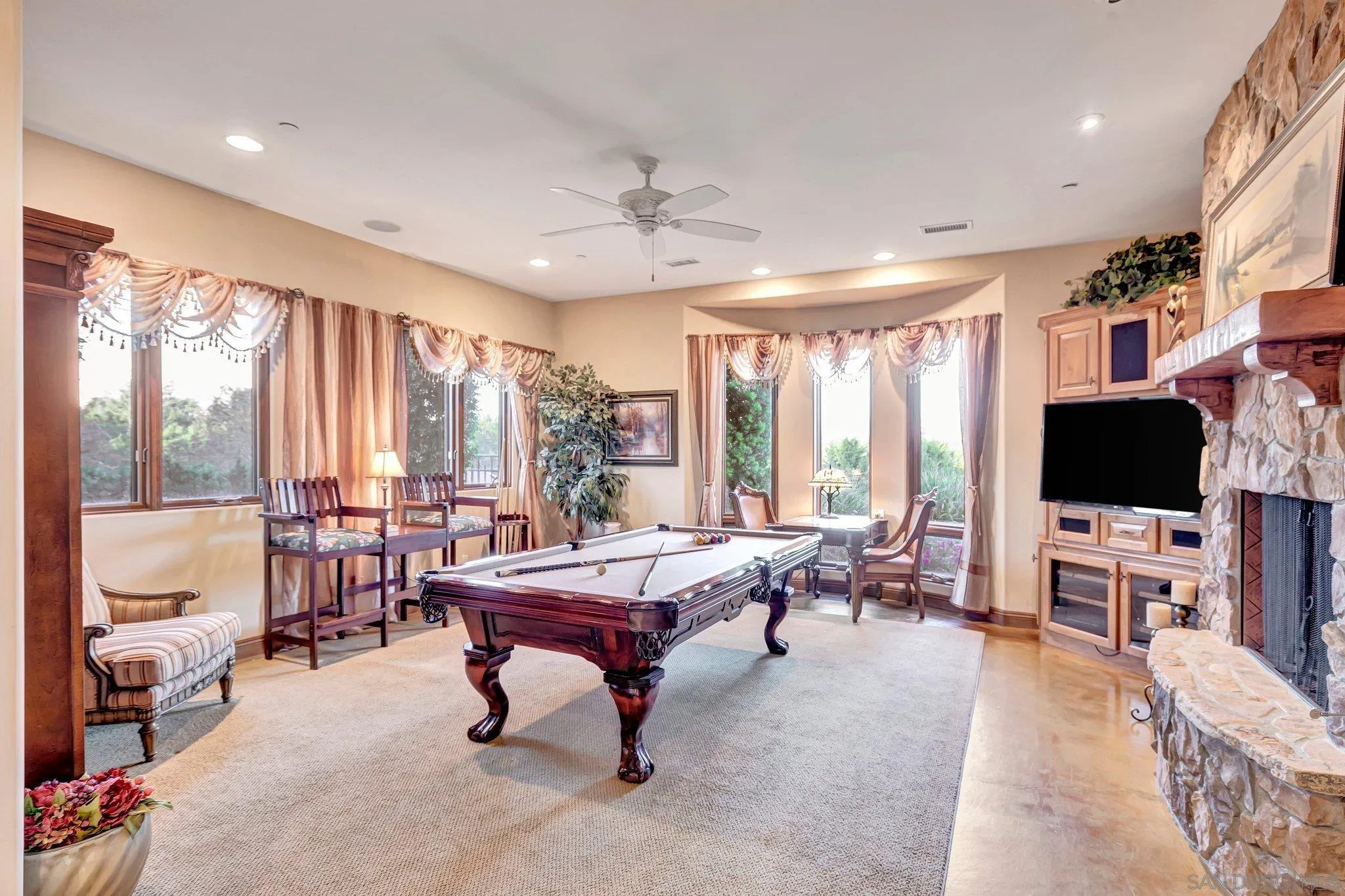 3401 Preakness Court Fallbrook, CA 92028 - Photo 27 of 52 a living room with furniture a flat screen tv and a large window