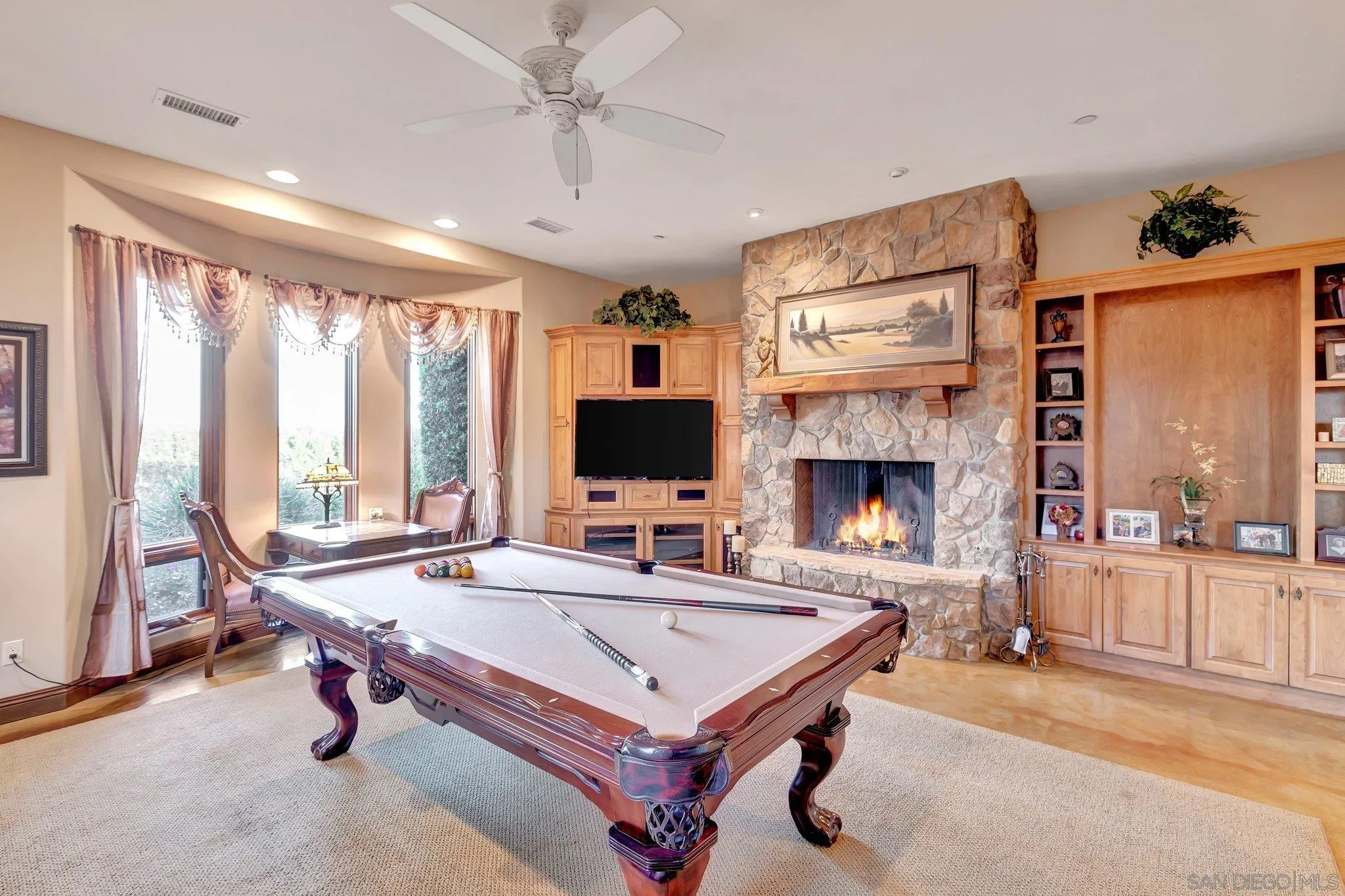 3401 Preakness Court Fallbrook, CA 92028 - Photo 28 of 52 a living room with furniture a flat screen tv and a fireplace