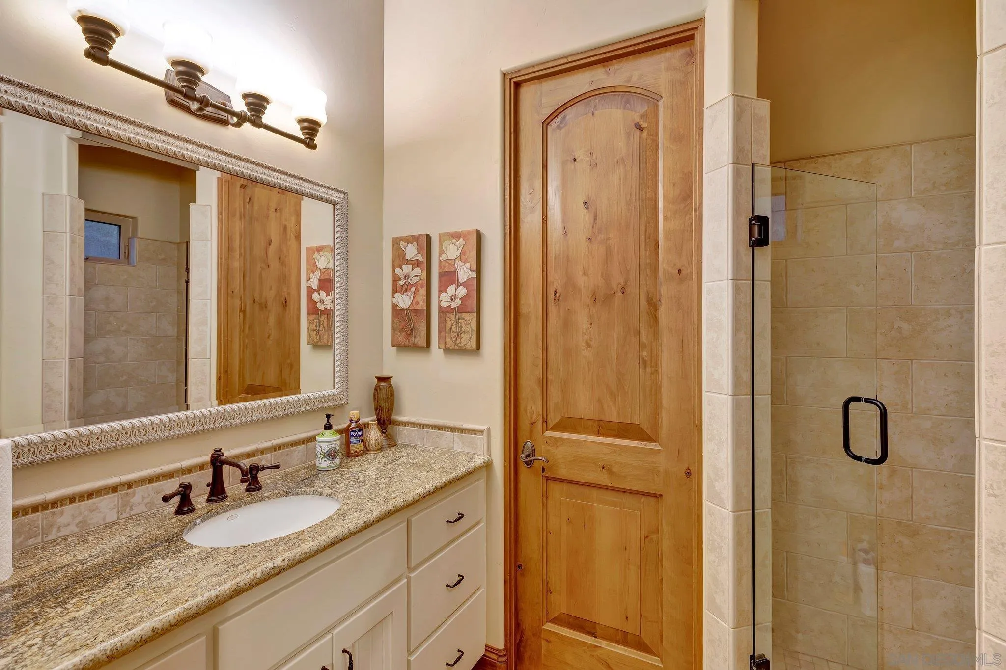 3401 Preakness Court Fallbrook, CA 92028 - Photo 30 of 52 a bathroom with a granite countertop sink a mirror and shower