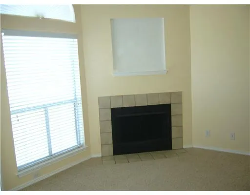 a living room with a fireplace and a window