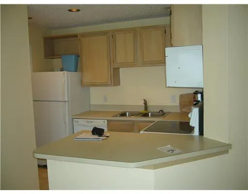 a bathroom with a sink and a refrigerator