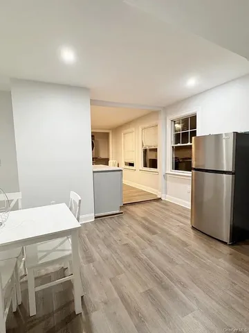 a kitchen with a refrigerator and a sink
