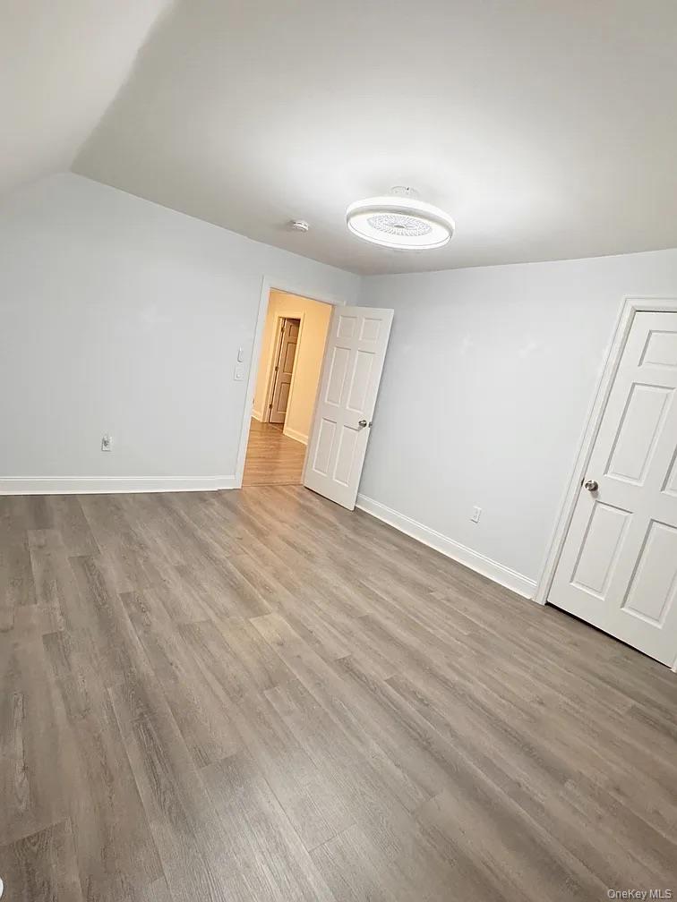 57 Pintard Avenue, Unit 3 New Rochelle, NY 10801 - Photo 8 of 23 an empty room with wooden floor and windows