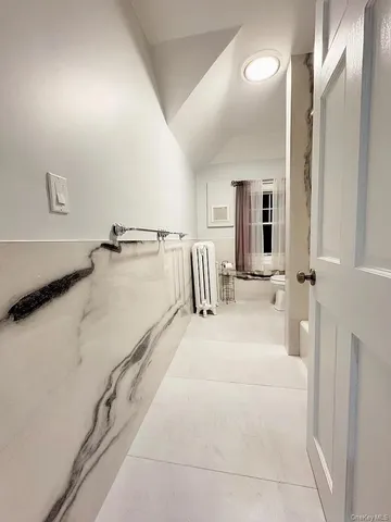 a bathroom with a tub sink and mirror