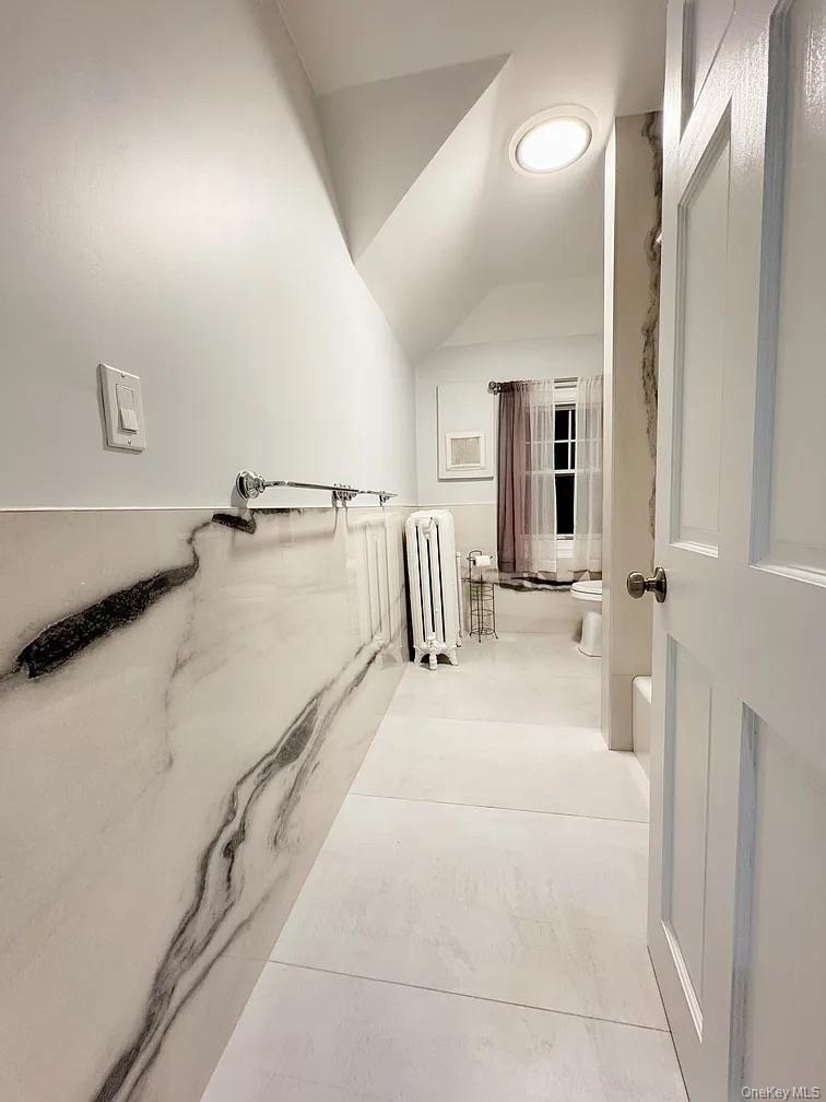 57 Pintard Avenue, Unit 3 New Rochelle, NY 10801 - Photo 9 of 23 a bathroom with a tub sink and mirror