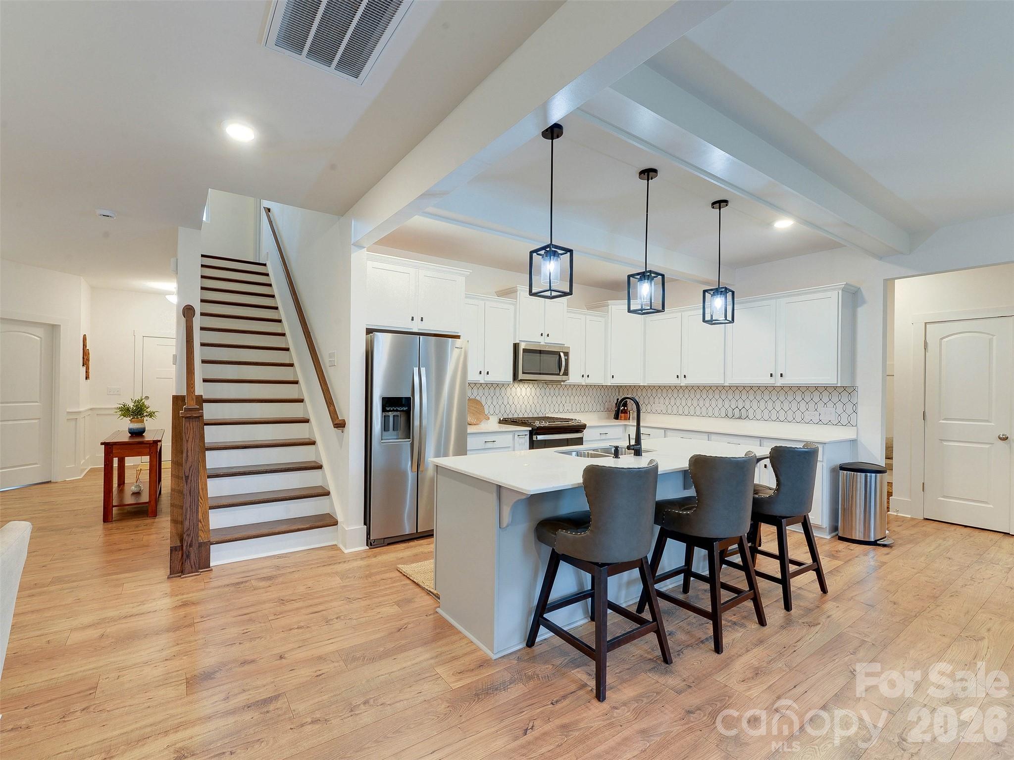 1928 Thoreau Way York, SC 29745 - Photo 2 of 43 a kitchen with stainless steel appliances kitchen island granite countertop lots of white cabinets and wooden floor