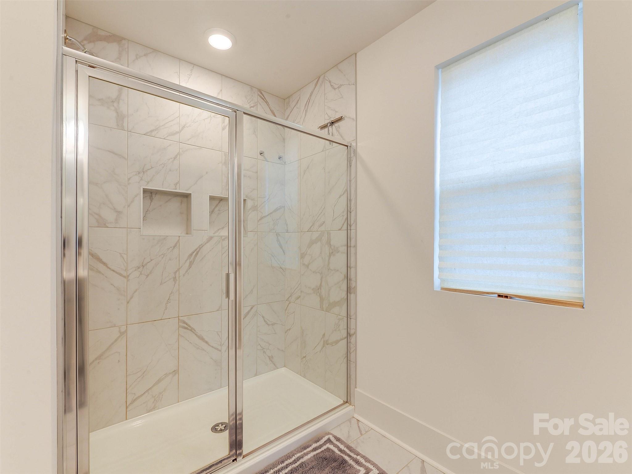 1928 Thoreau Way York, SC 29745 - Photo 28 of 43 a bathroom with a glass shower door