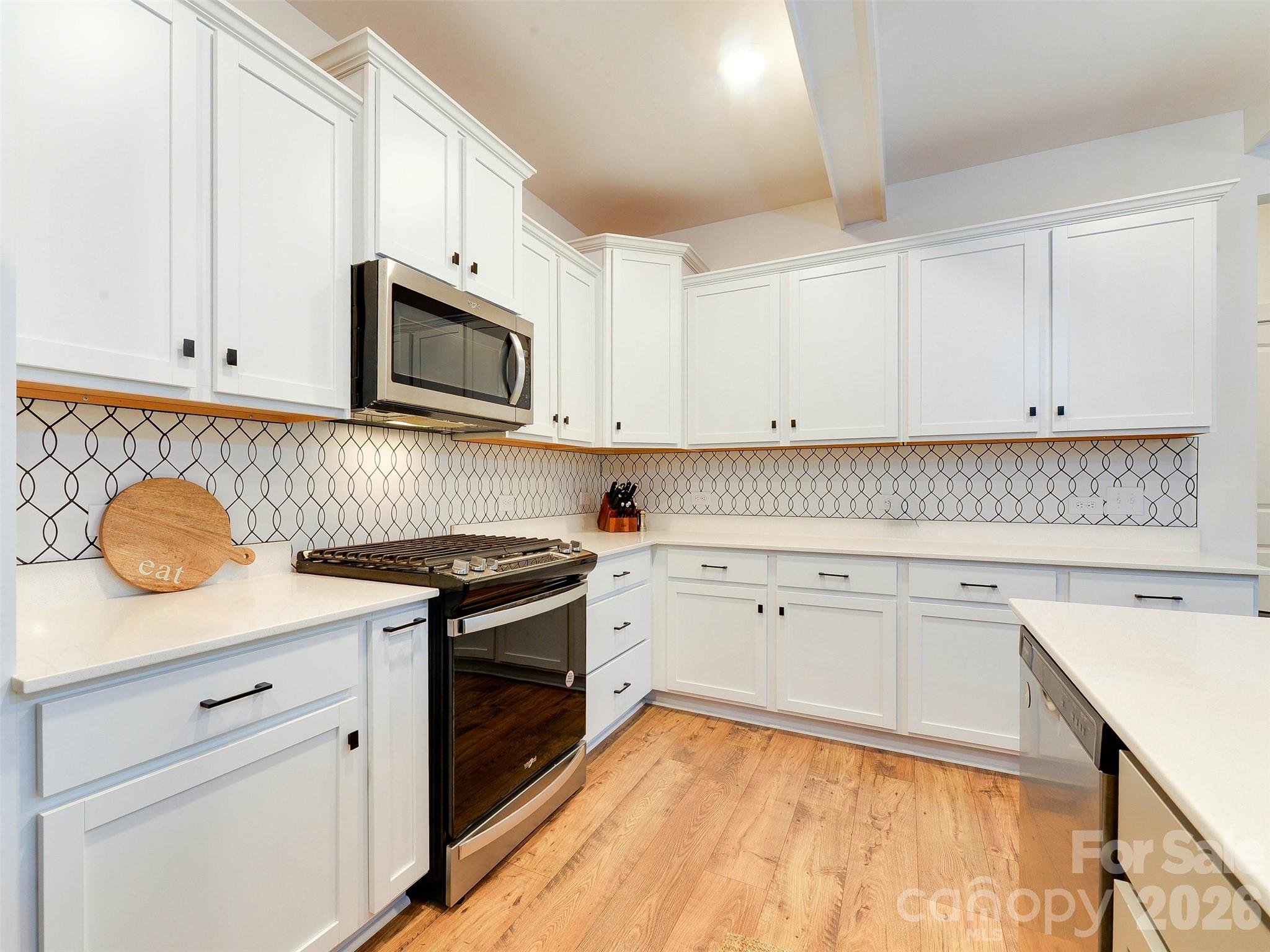 1928 Thoreau Way York, SC 29745 - Photo 4 of 43 a kitchen with granite countertop cabinets stainless steel appliances and wooden floor