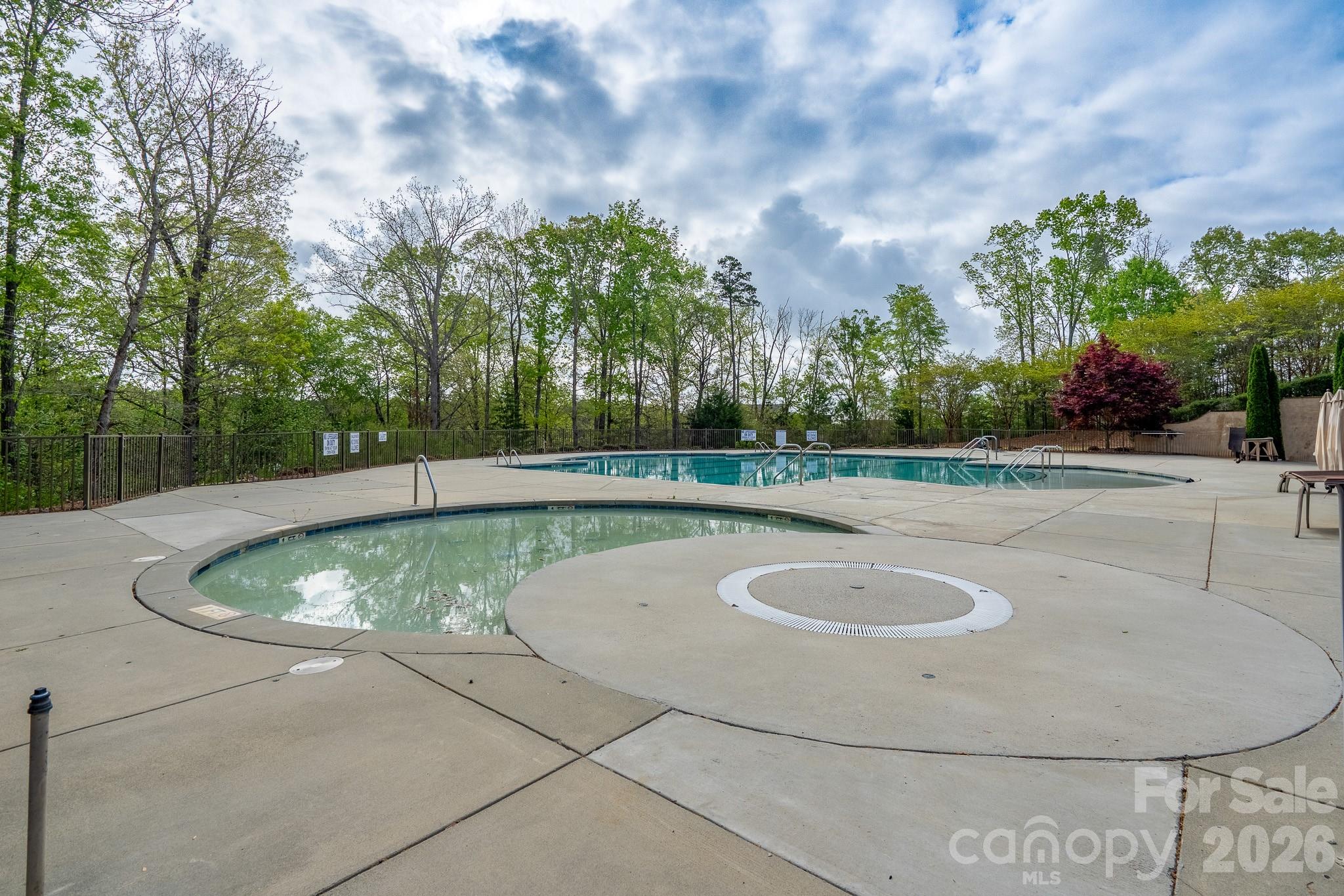 1928 Thoreau Way York, SC 29745 - Photo 41 of 43 a view of a swimming pool with a yard and trees in the background