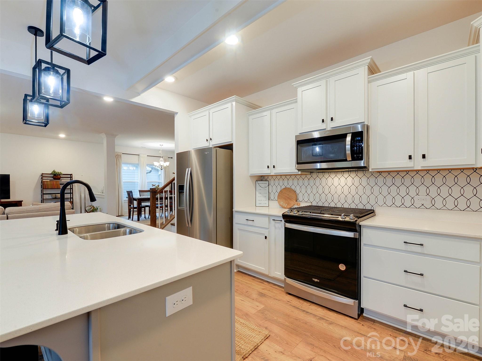 1928 Thoreau Way York, SC 29745 - Photo 6 of 43 a kitchen with kitchen island granite countertop a sink cabinets and stainless steel appliances