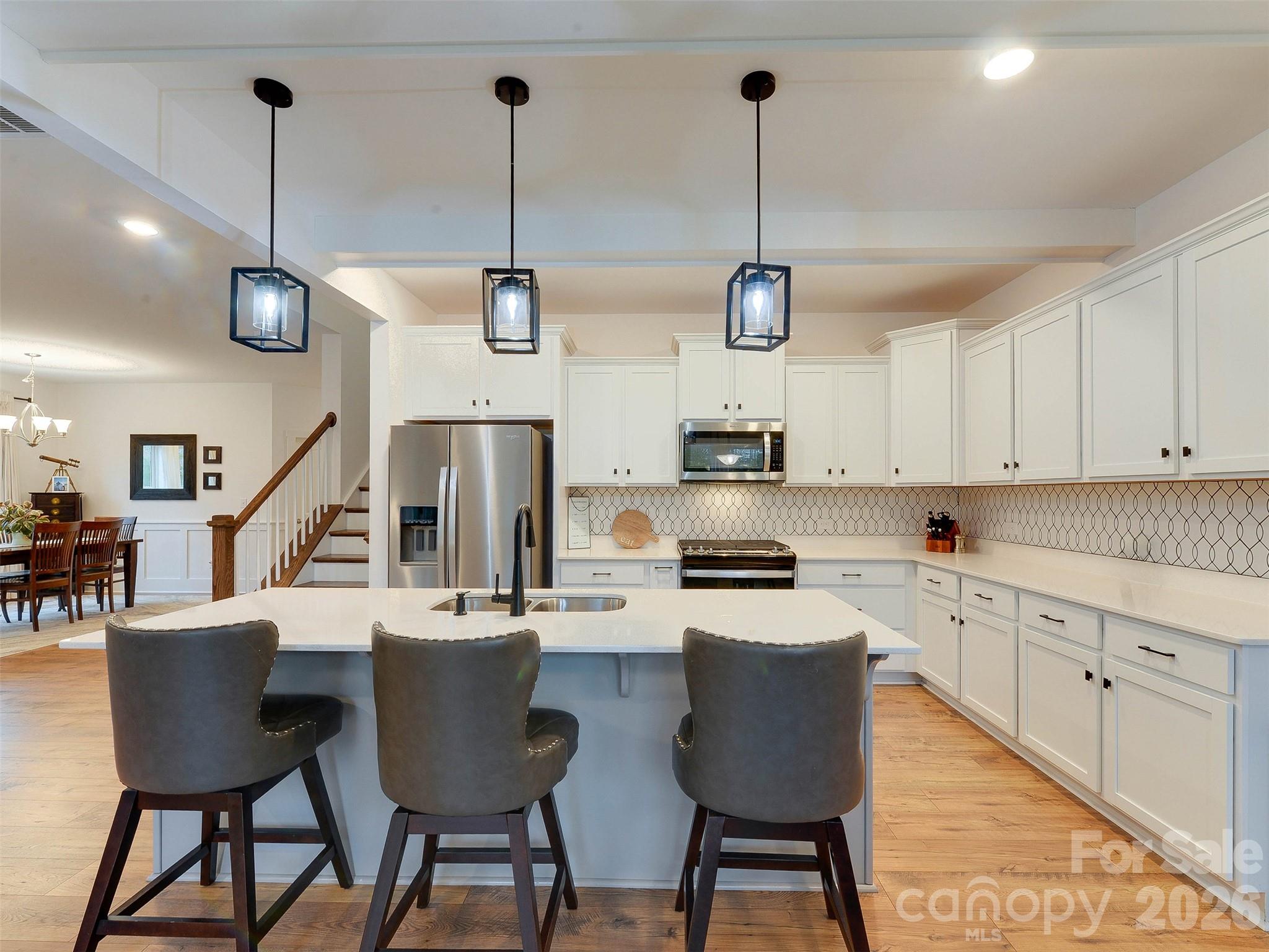 1928 Thoreau Way York, SC 29745 - Photo 7 of 43 a kitchen with stainless steel appliances kitchen island a dining table chairs and a sink