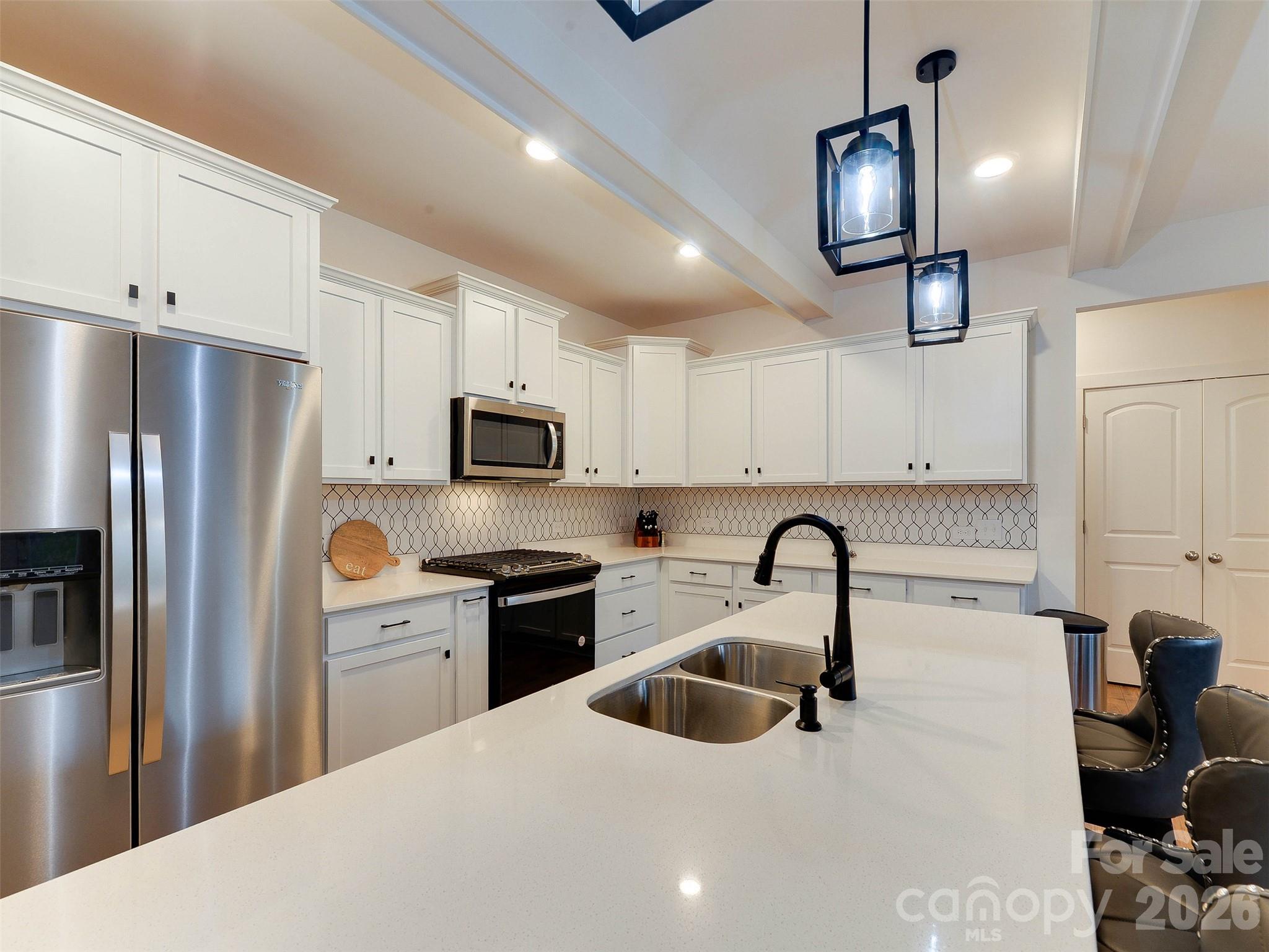1928 Thoreau Way York, SC 29745 - Photo 9 of 43 a kitchen with stainless steel appliances kitchen island a refrigerator and a stove top oven