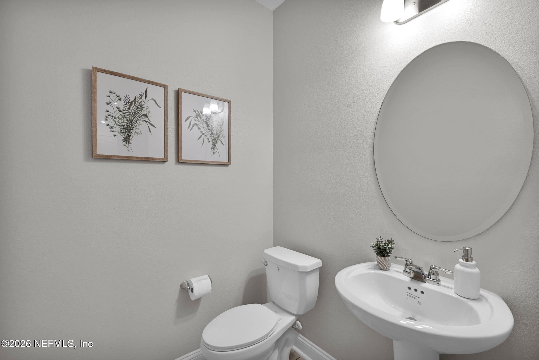 4050 Coyote Court Middleburg, FL 32068 - Photo 11 of 93 a bathroom with a toilet sink and mirror