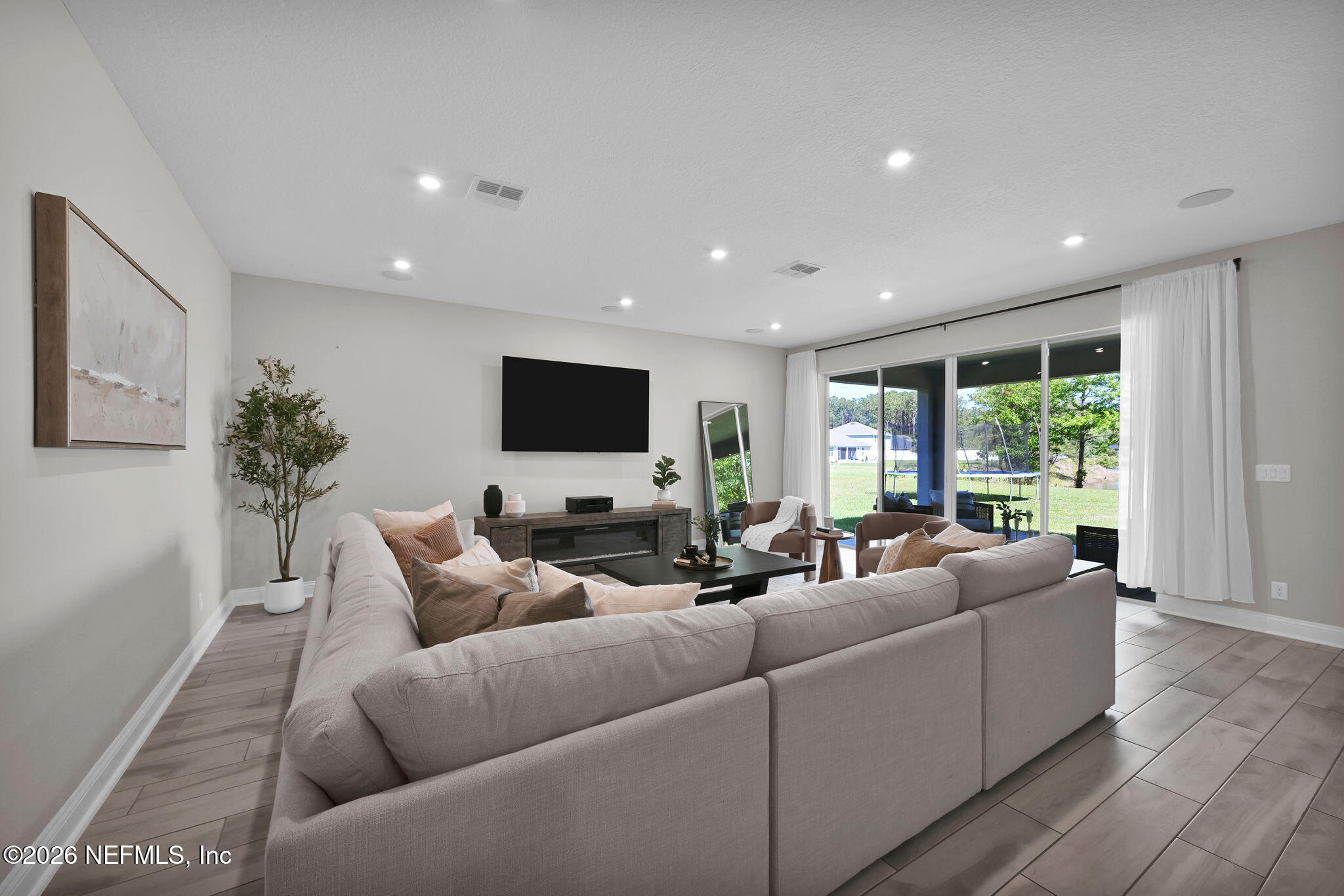 4050 Coyote Court Middleburg, FL 32068 - Photo 12 of 93 a living room with furniture and a flat screen tv
