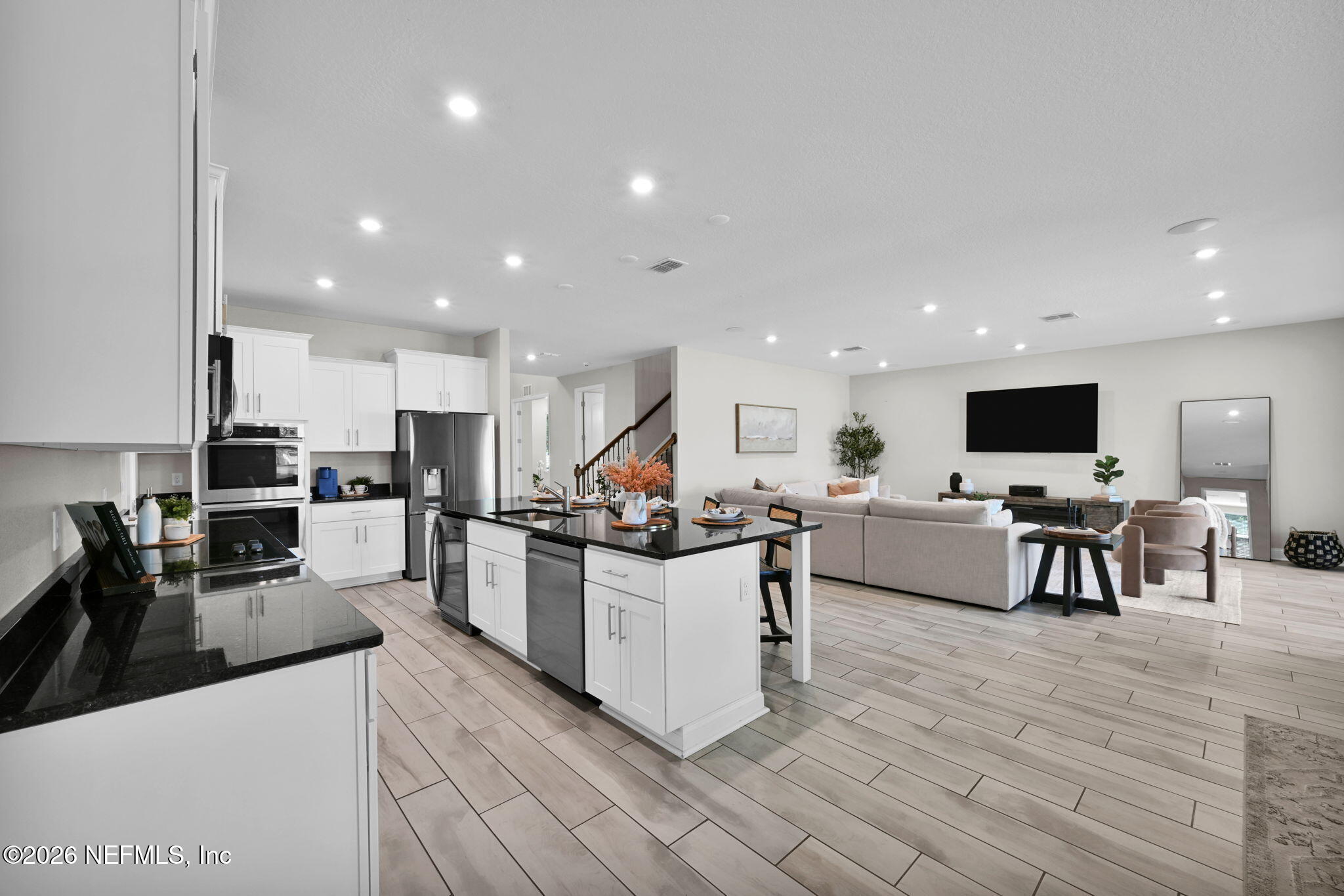 4050 Coyote Court Middleburg, FL 32068 - Photo 20 of 93 a kitchen with stainless steel appliances kitchen island granite countertop a table chairs stove and cabinets