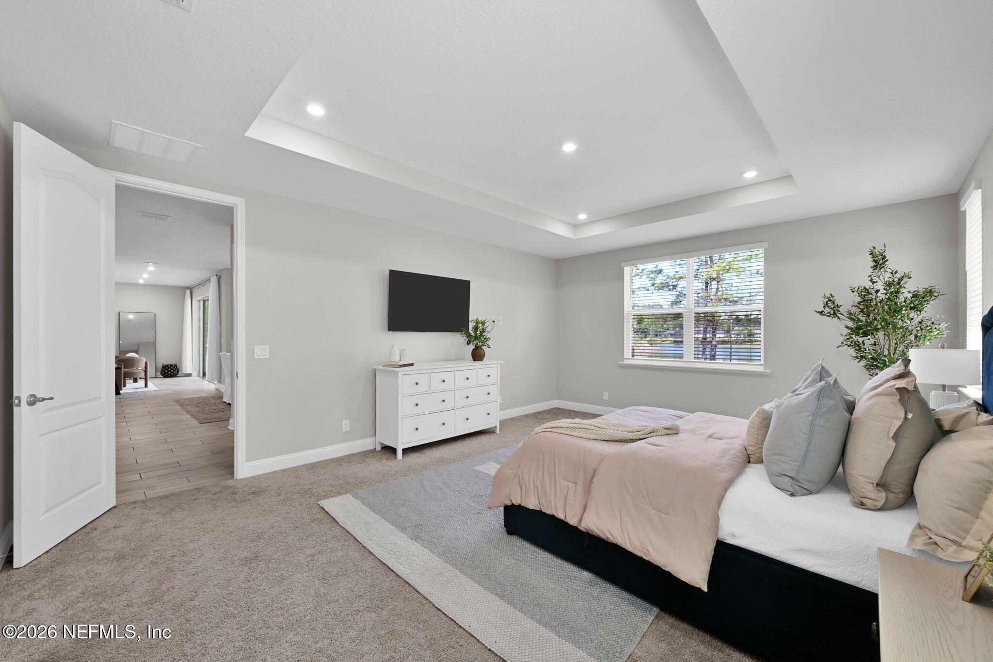 4050 Coyote Court Middleburg, FL 32068 - Photo 31 of 93 a bedroom with a bed and a flat screen tv