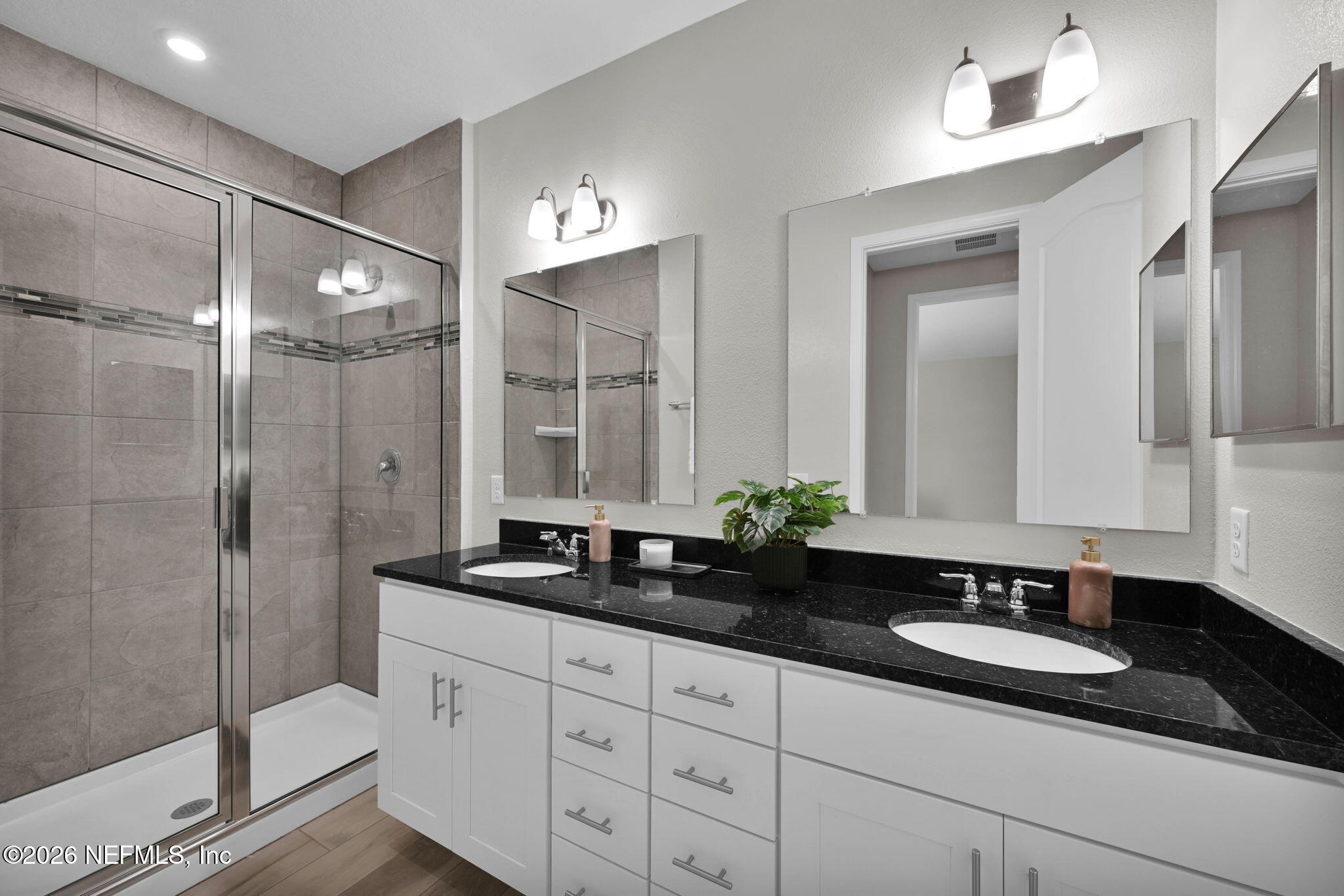 4050 Coyote Court Middleburg, FL 32068 - Photo 48 of 93 a bathroom with a granite countertop sink a mirror a and a shower