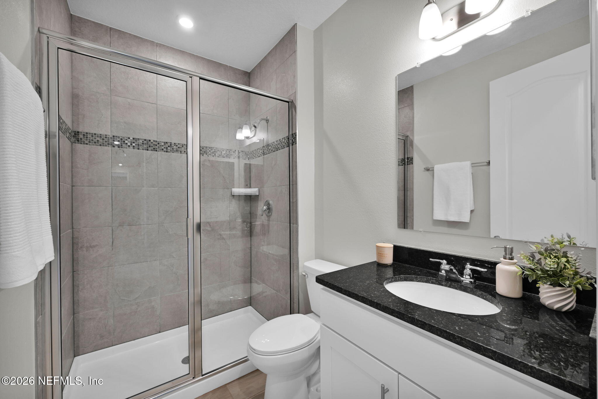 4050 Coyote Court Middleburg, FL 32068 - Photo 50 of 93 a bathroom with a granite countertop sink a toilet and shower