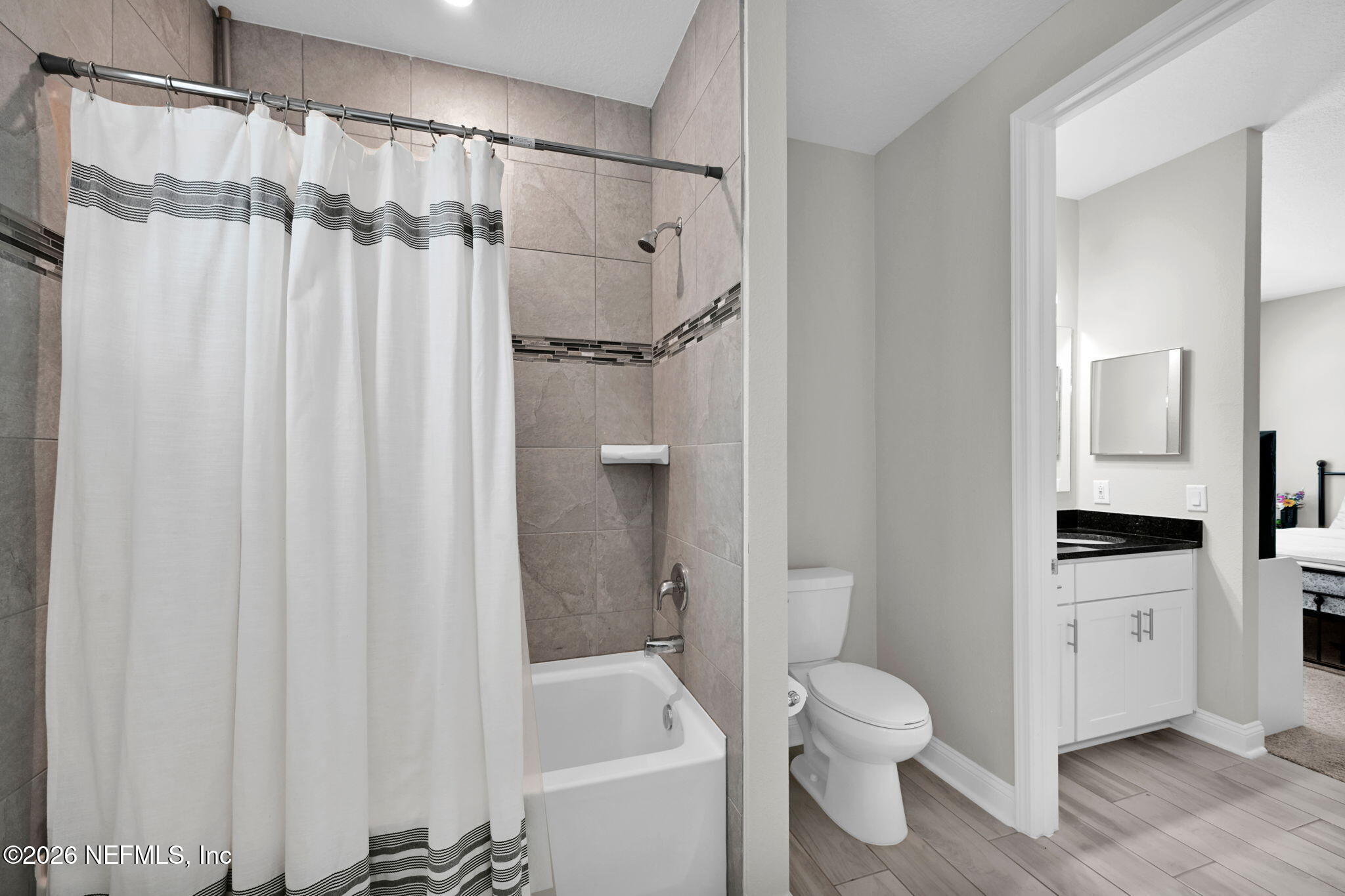 4050 Coyote Court Middleburg, FL 32068 - Photo 58 of 93 a bathroom with a shower curtain a sink and a toilet