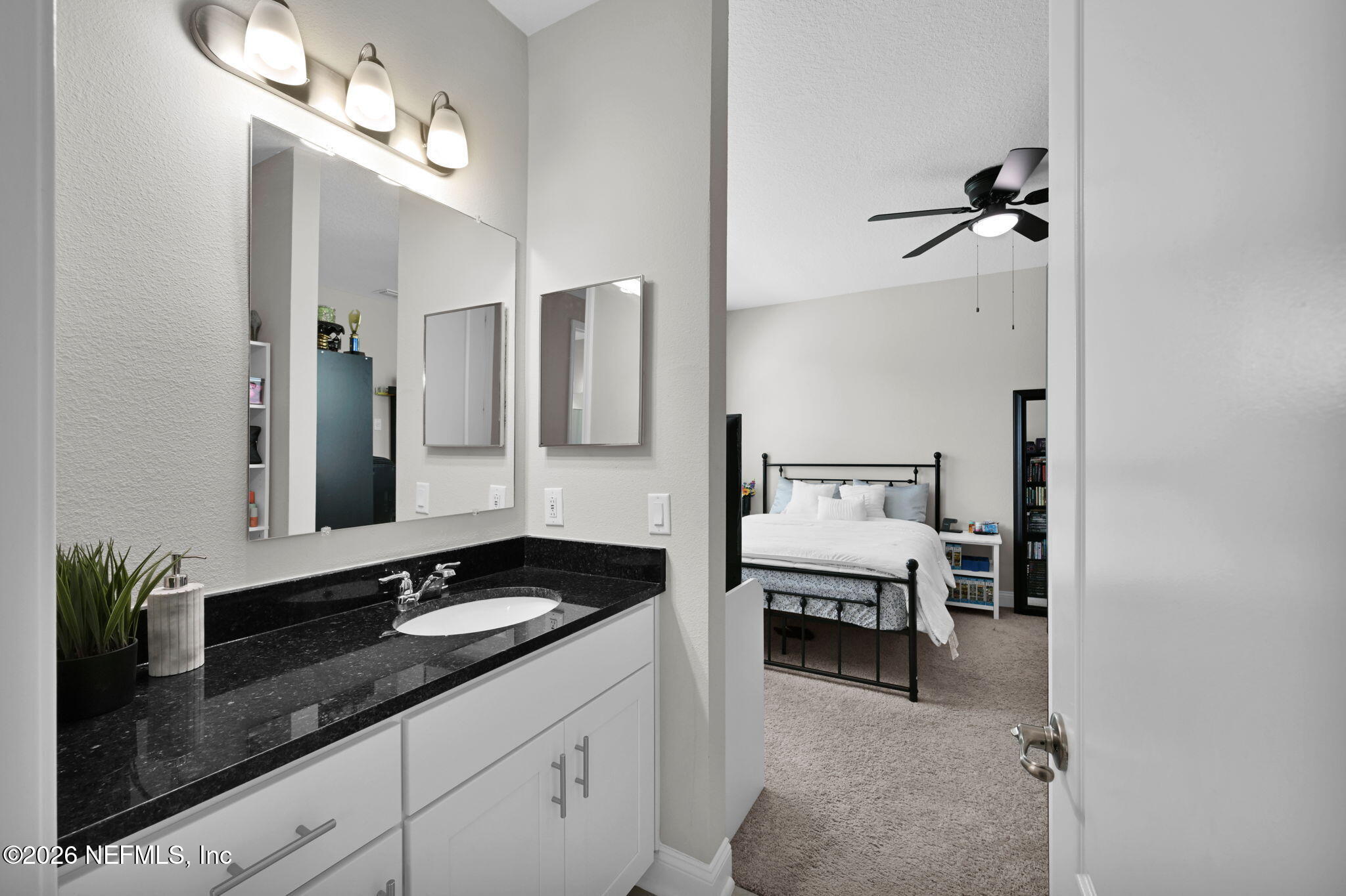4050 Coyote Court Middleburg, FL 32068 - Photo 60 of 93 a en suite bathroom with a granite countertop sink and a mirror