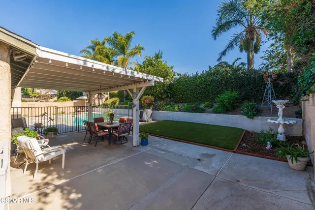 a view of a house with a yard and sitting area