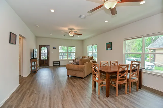 a dining room with furniture window and wooden floor