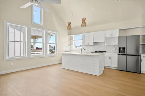 a kitchen with a refrigerator oven a sink and a stove top oven
