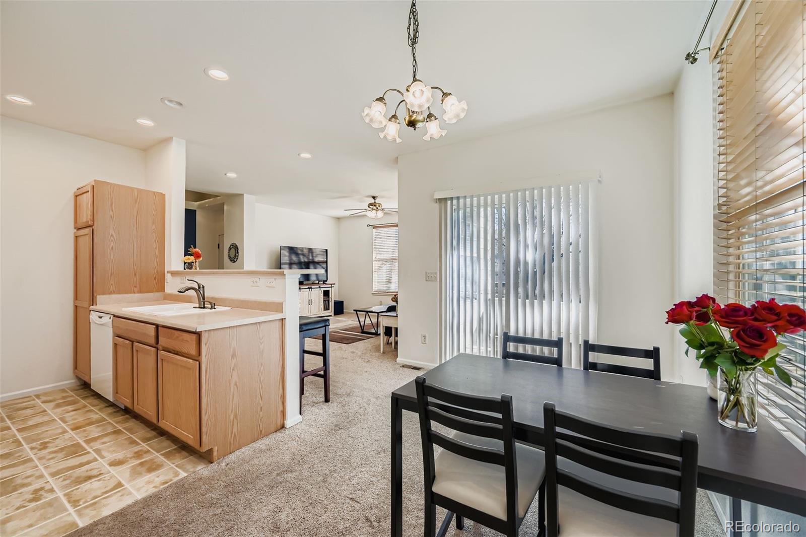 208 Remuda Lane Lafayette, CO 80026 - Photo 11 of 28 a kitchen with a refrigerator and a table