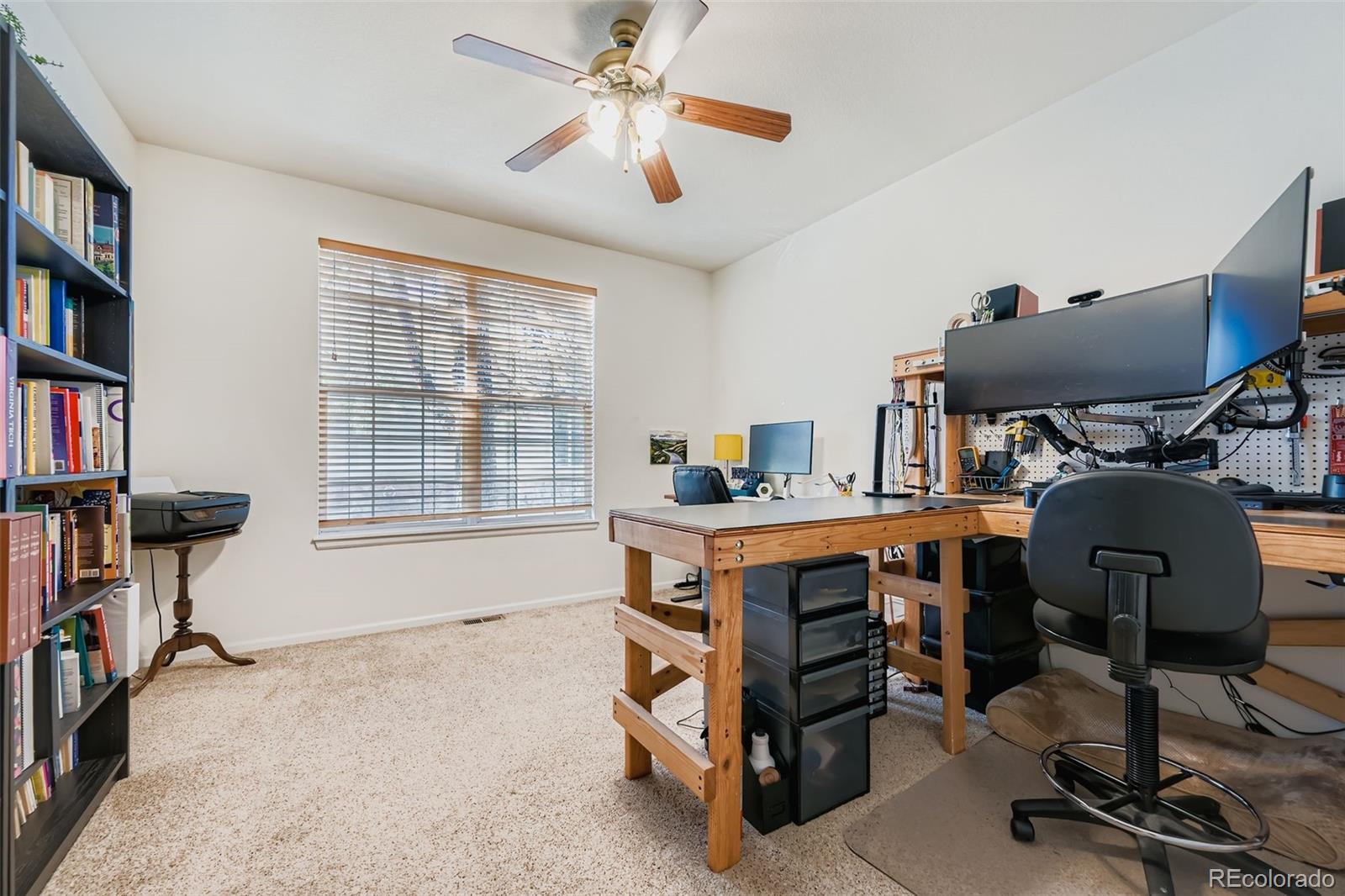 208 Remuda Lane Lafayette, CO 80026 - Photo 12 of 28 a view of a workspace with furniture and a window