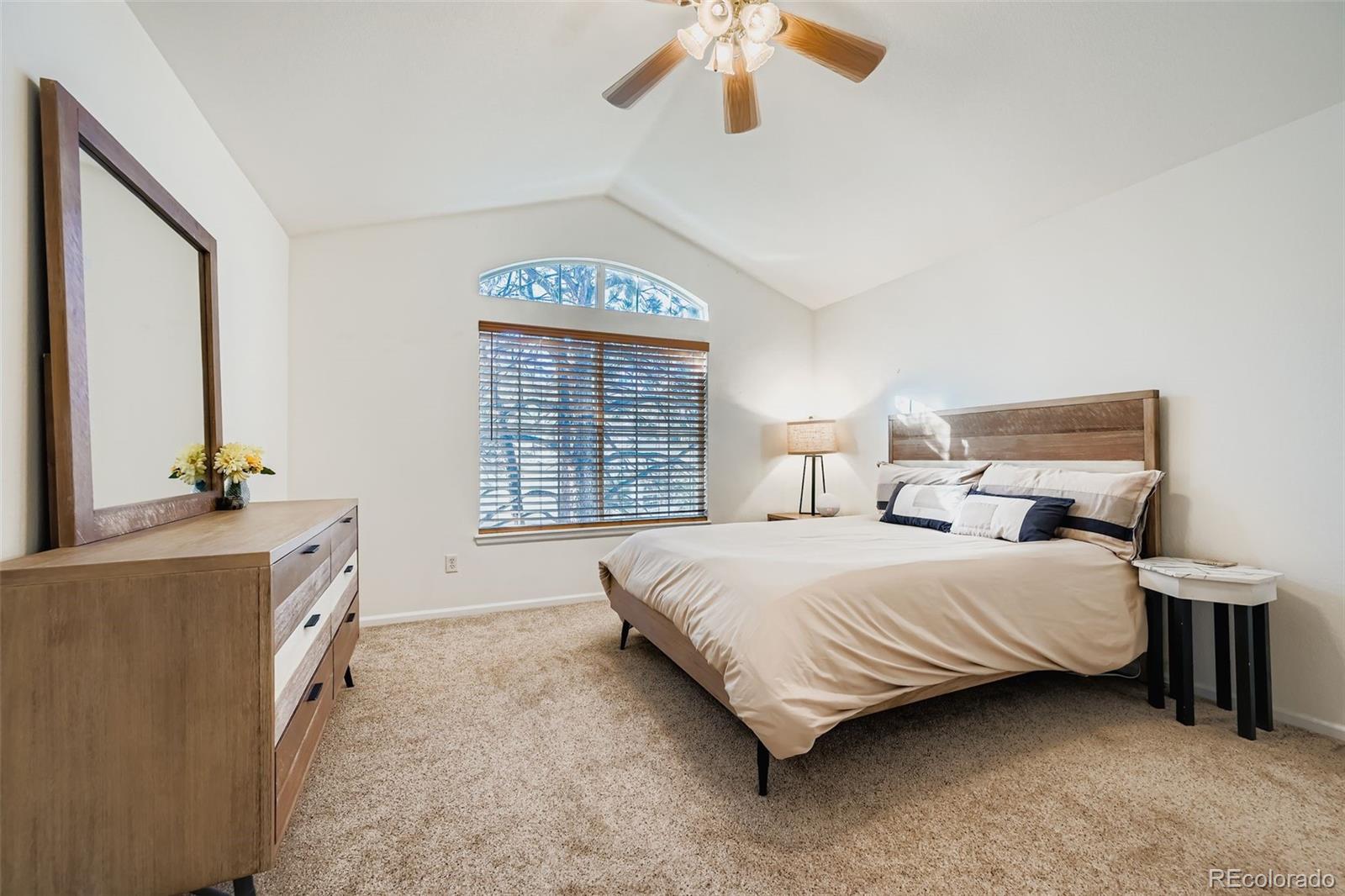 208 Remuda Lane Lafayette, CO 80026 - Photo 15 of 28 a bedroom with a bed and a chandelier