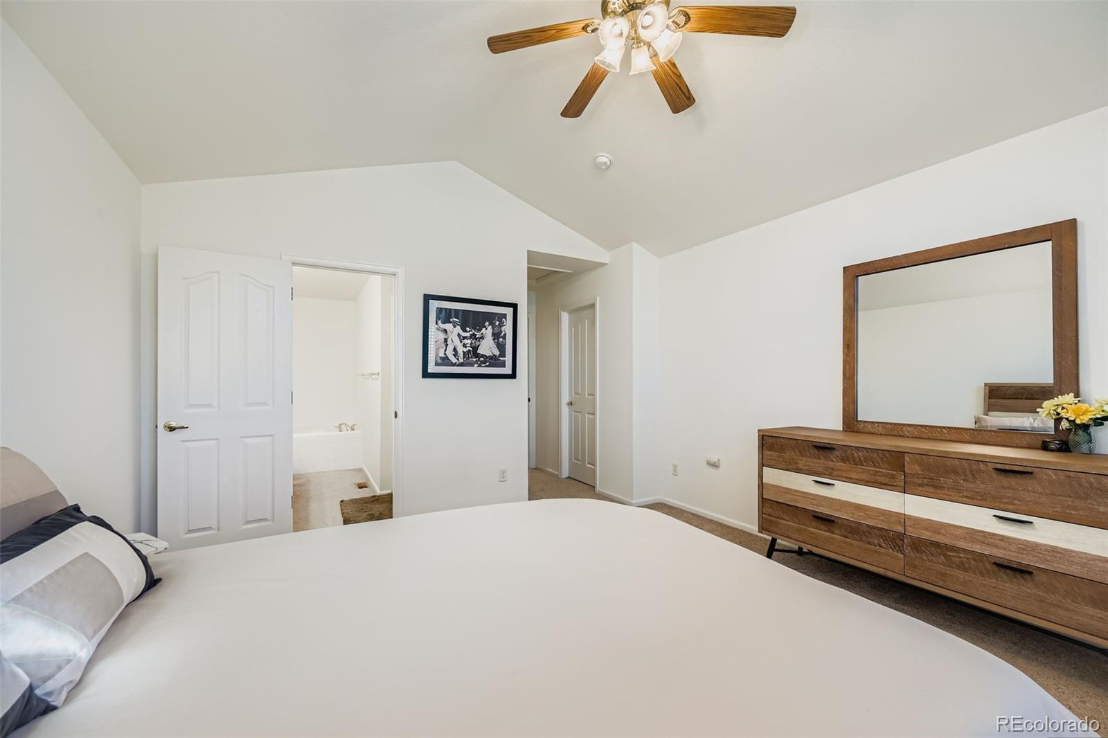 208 Remuda Lane Lafayette, CO 80026 - Photo 18 of 28 a bedroom with a bed and a chandelier