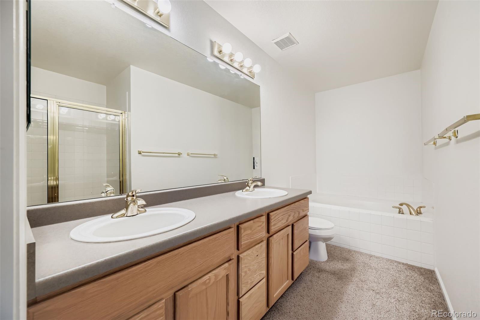 208 Remuda Lane Lafayette, CO 80026 - Photo 19 of 28 a bathroom with a double vanity sink and a mirror